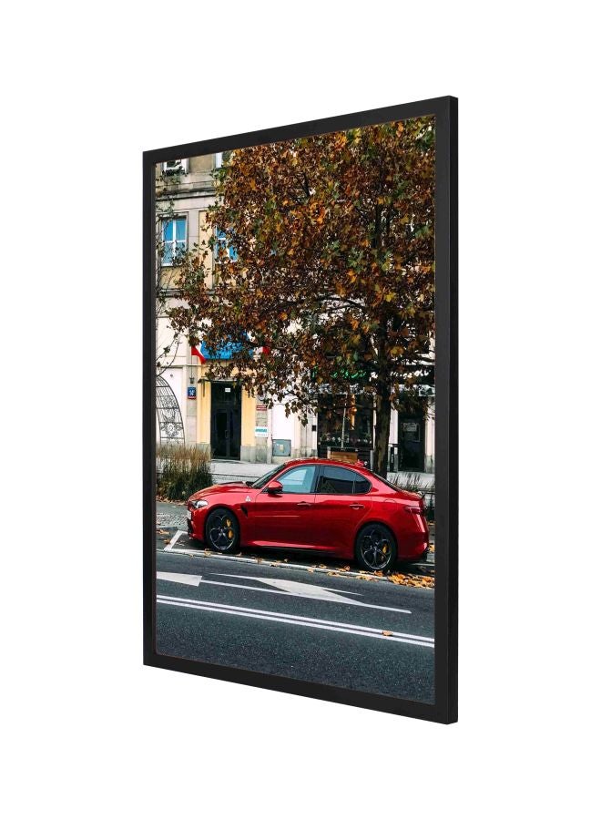 لوحة لديكور الحائط تمثل سيارة رياضية حمراء تحت الشجرة ومزودة بإطار أحمر / أسود / أخضر 73x53سم - Image 1