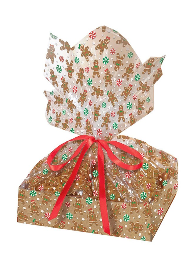 أمسكان صينية حلوى كبيرة على شكل خبز الزنجبيل مع أكياس تشيلو