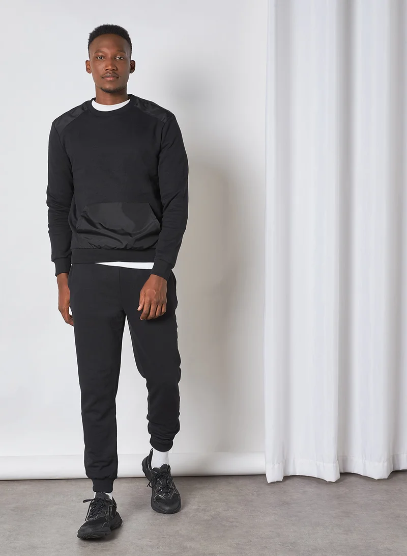 ترينديول بدلة رياضية من قطعتين بتصميم قطع موصولة أسود