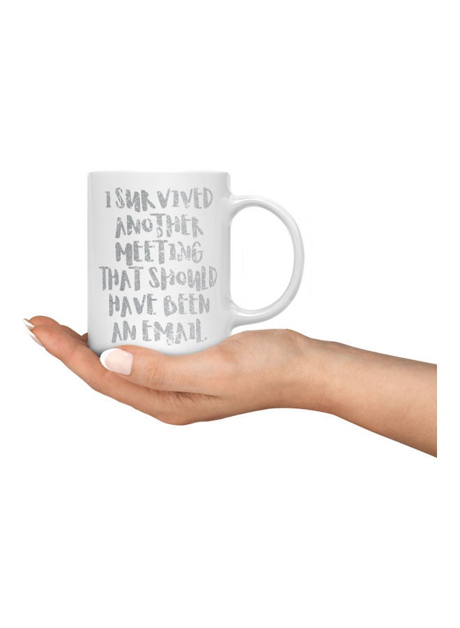 لاود يونيفيرس مج قهوة بطبعة عبارة "I Survived Another Meeting" أبيض/فضي. - Image 3