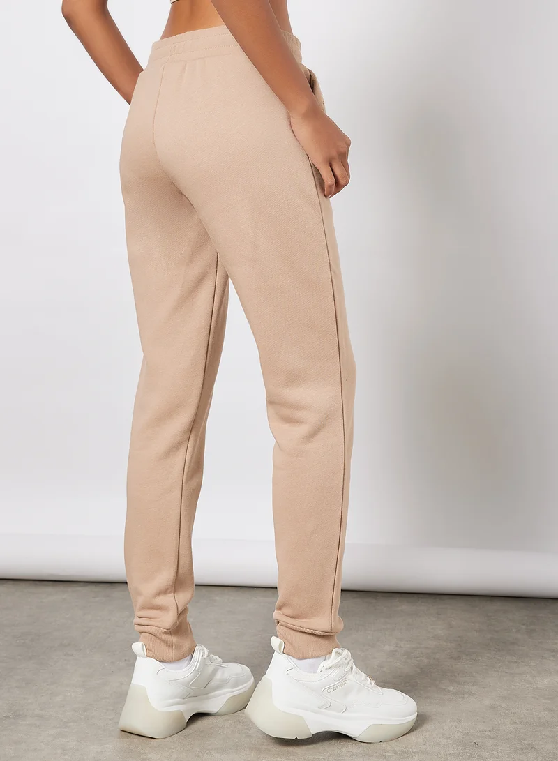 راسل اثليتك Logo Embellished Sweatpants Beige