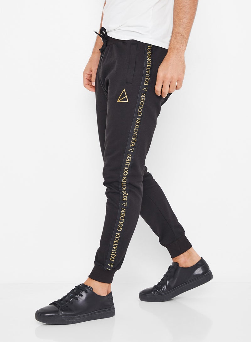 GOLDEN EQUATION - Logo Side Tape Detail Joggers Black - Image 1