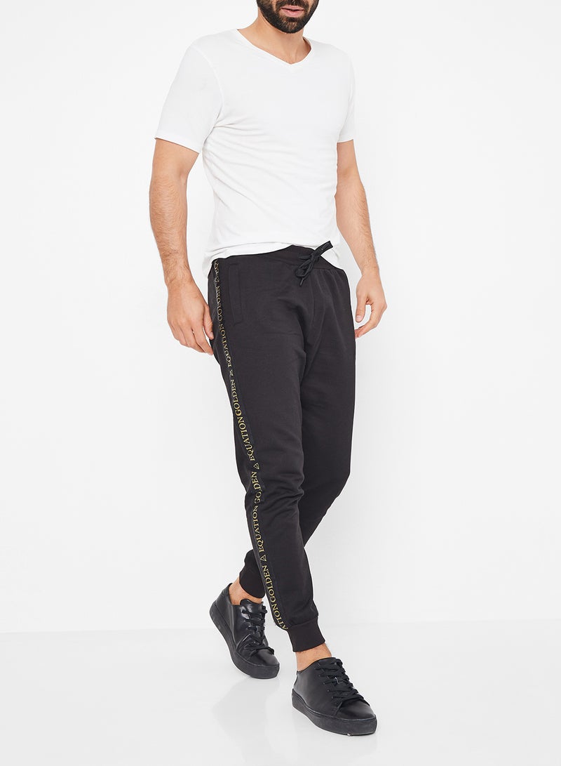 GOLDEN EQUATION - Logo Side Tape Detail Joggers Black - Image 1