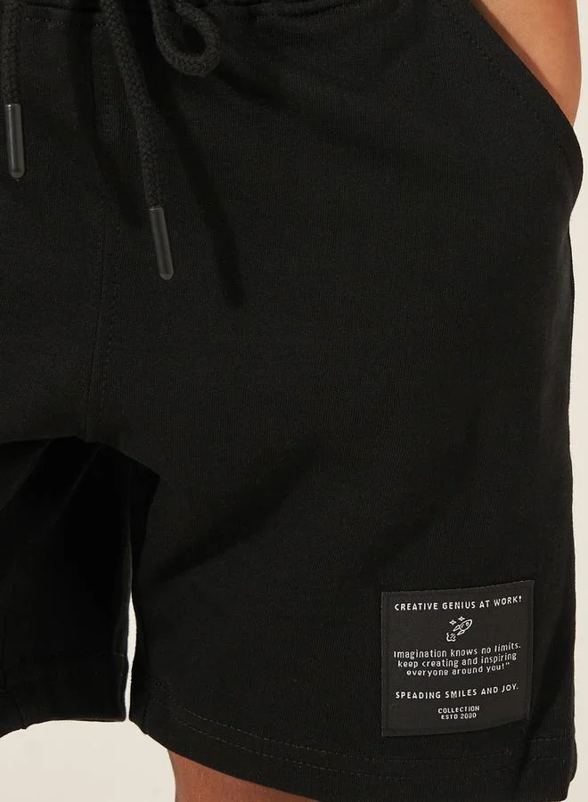 ستايلي Solid Drawstring Shorts with Badge Detail