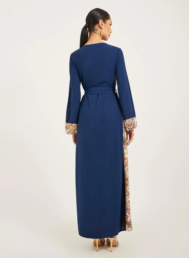 Styli navy olive colour jalabiya w/ navy blue pailsey print inserts at sides and slv cuff w/ gold cord trim at CF and sleeve hem