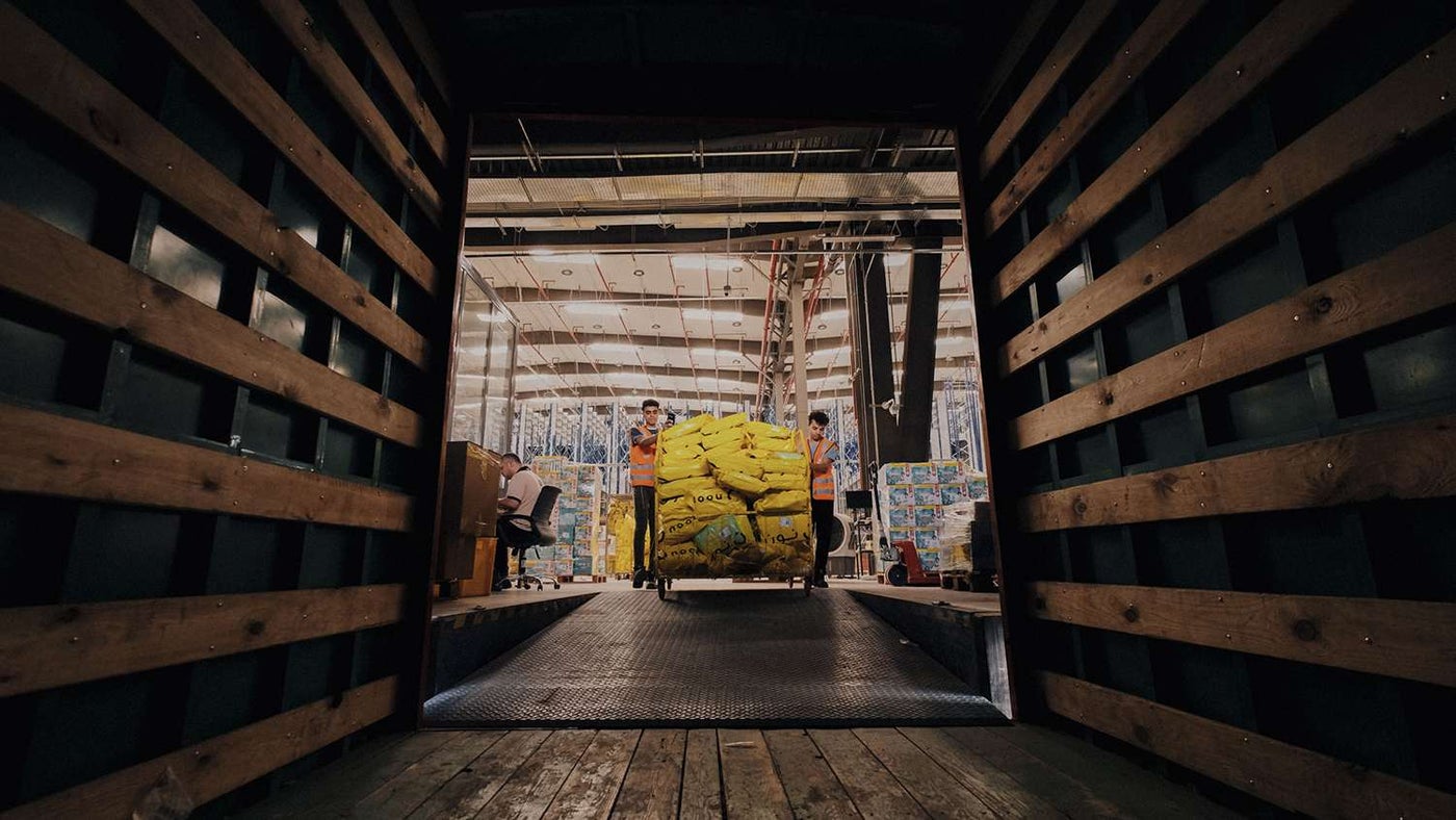 noon Employees loading packages into shipping crate