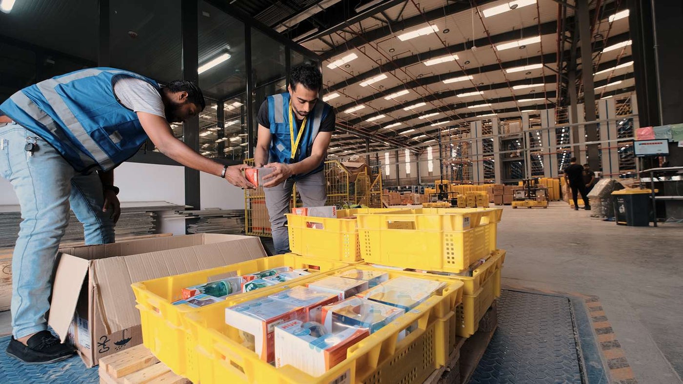 noon Employees packing items into crates